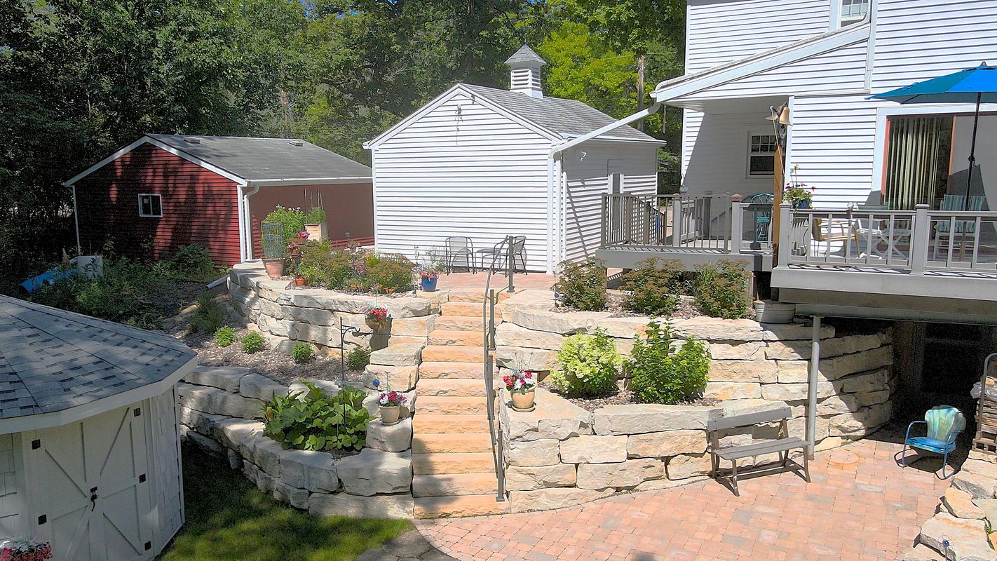 Tiered backyard patio with stone retaining walls