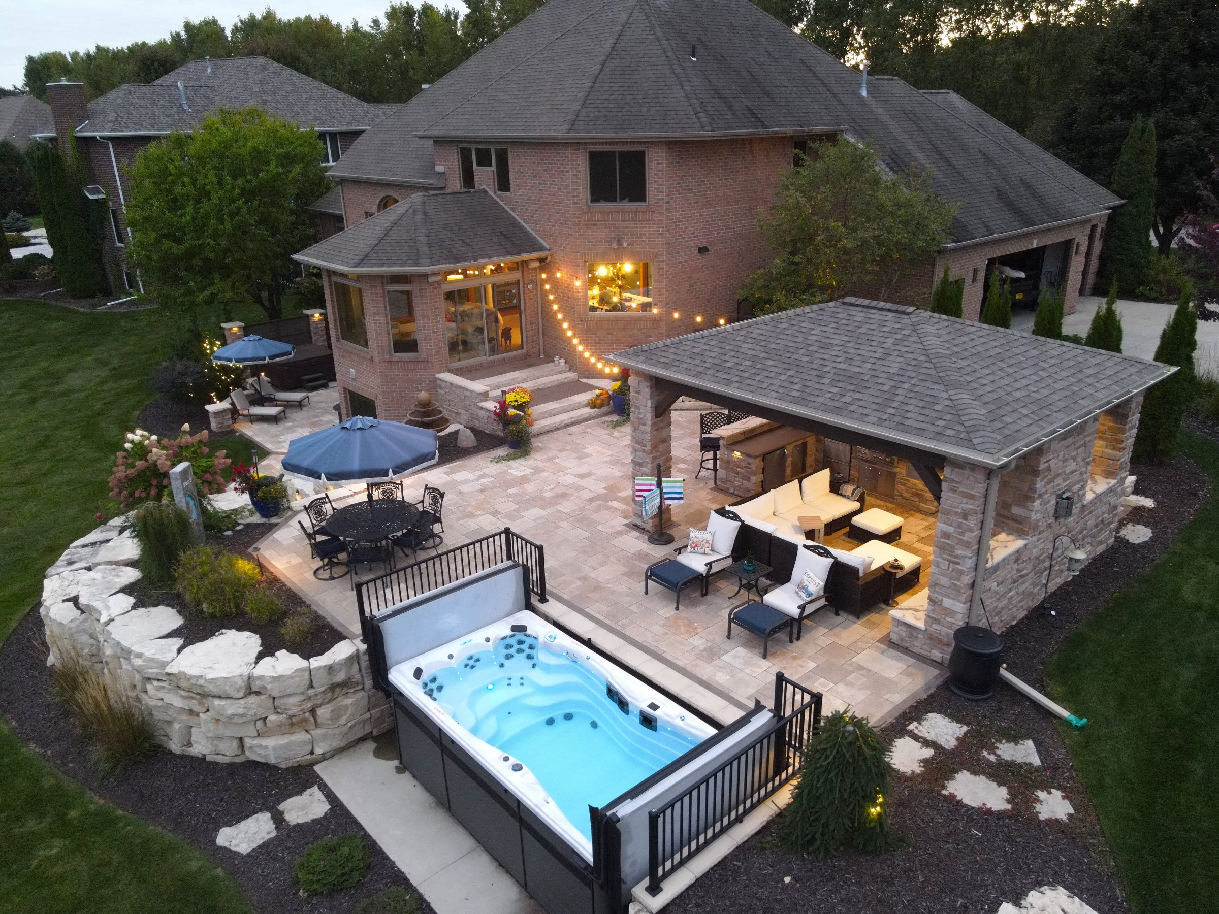 Luxury backyard patio with hot tub and outdoor kitchen