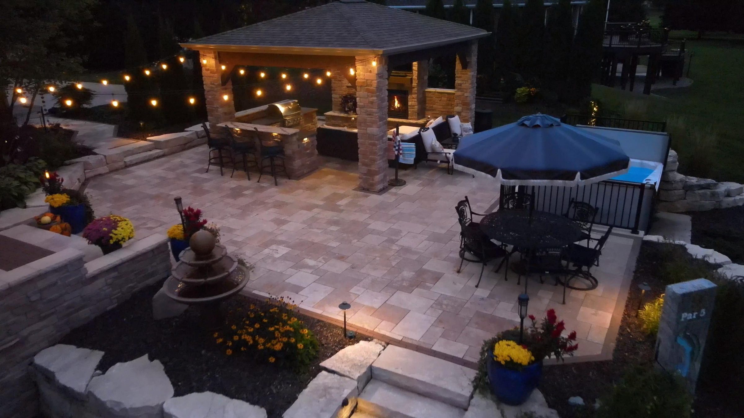 Outdoor patio with pavilion, fireplace, and string lights