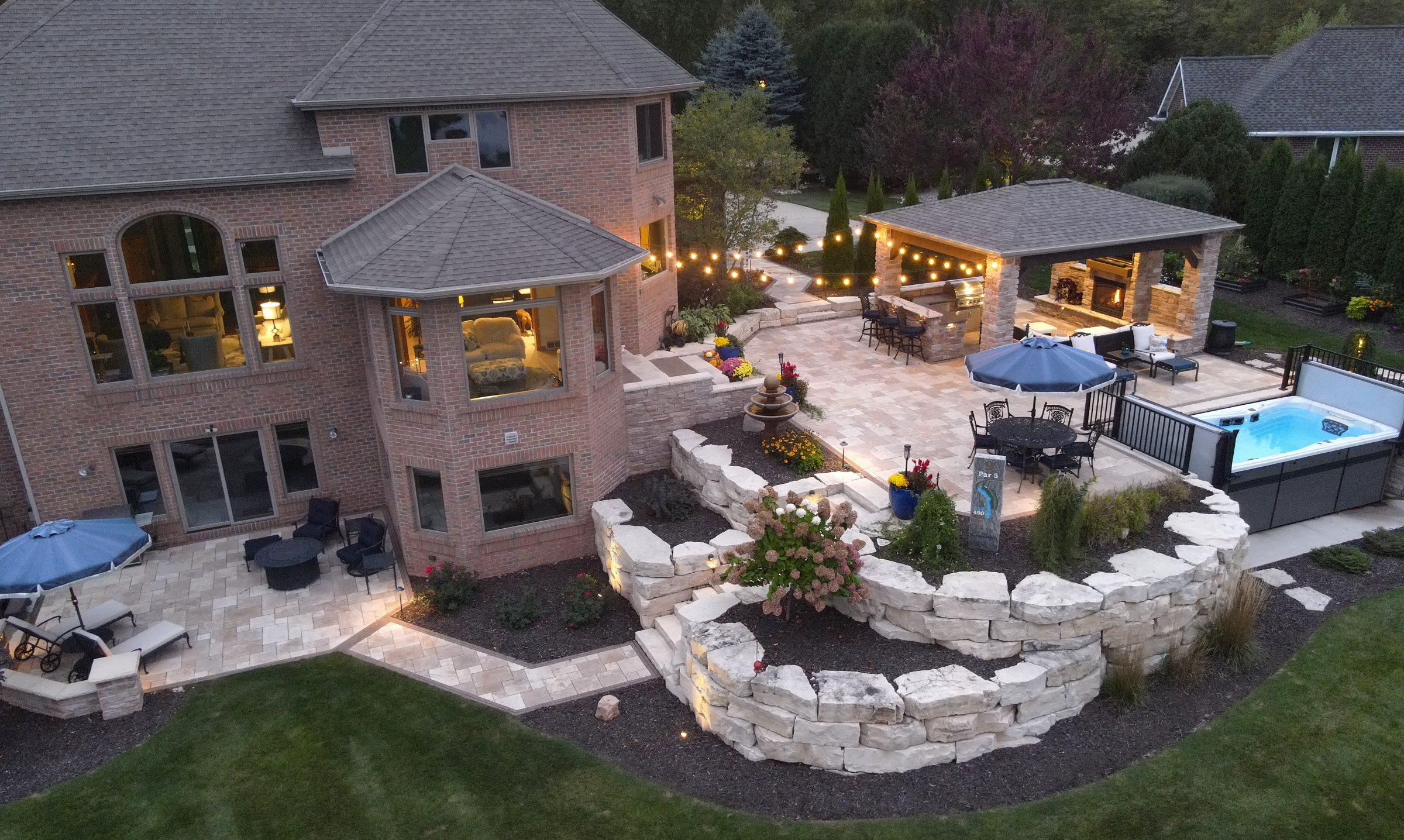 Luxury backyard patio with outdoor kitchen and hot tub