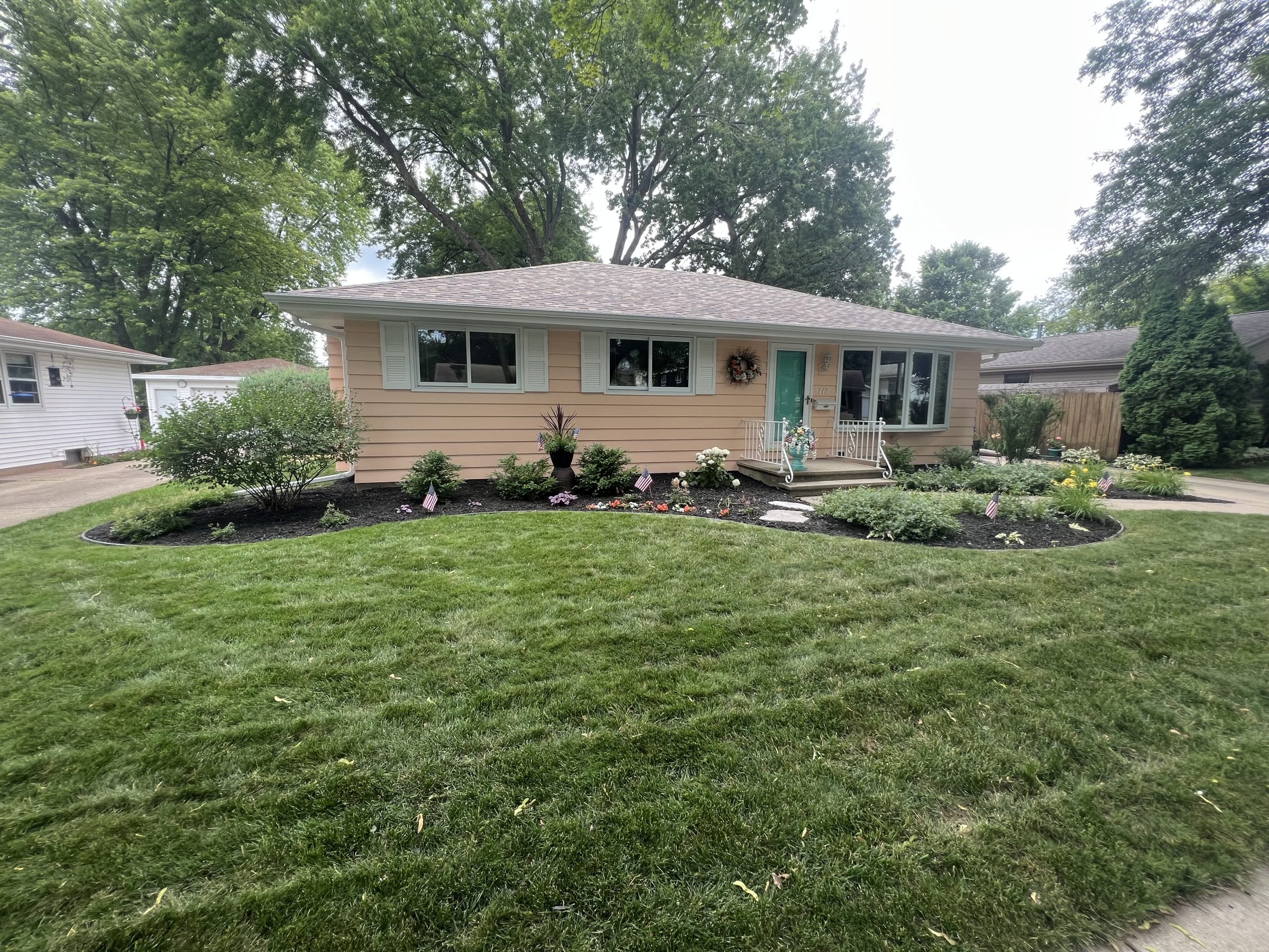 Single-story ranch home with landscaped front yard
