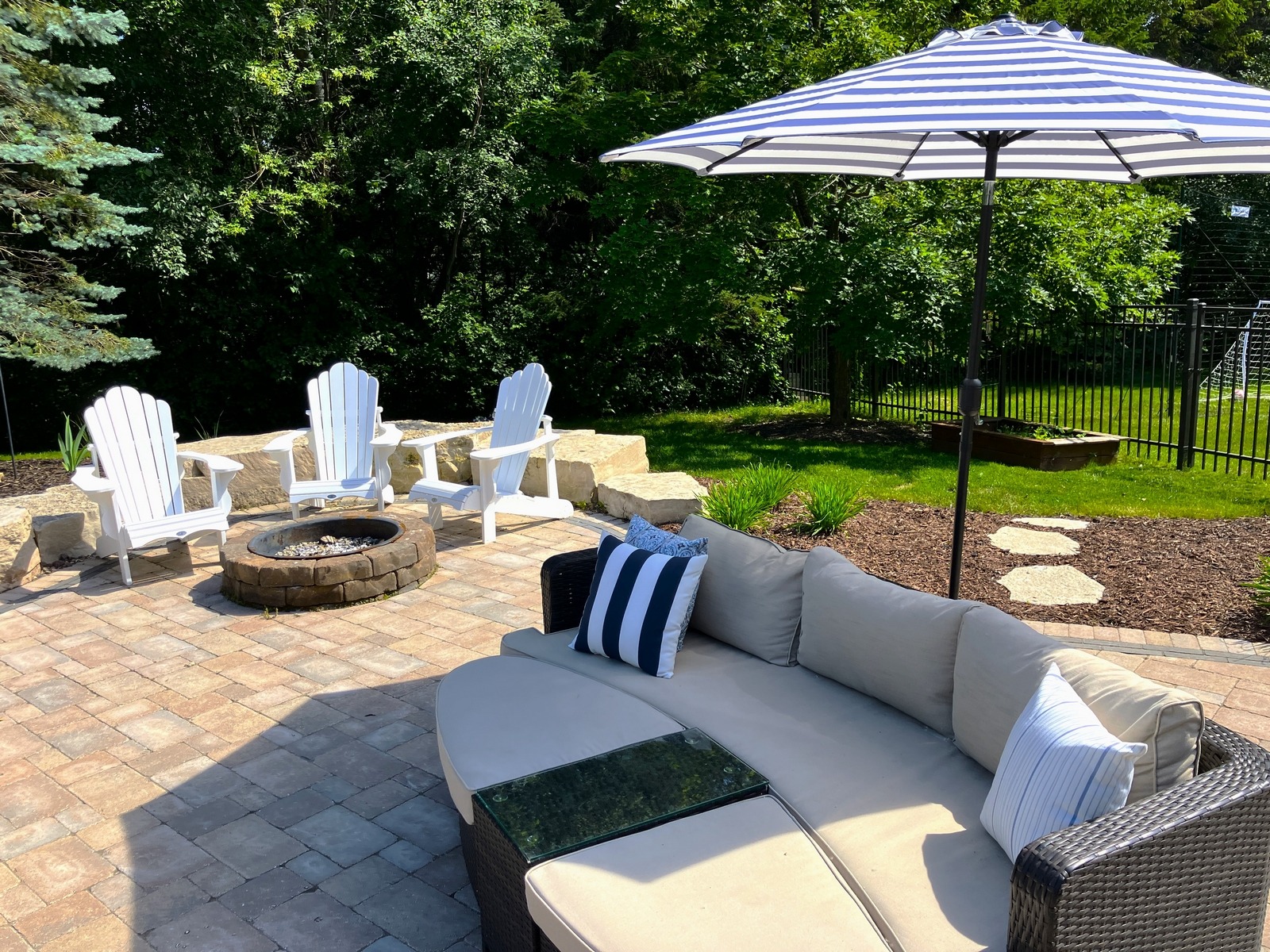 Backyard patio with fire pit and outdoor seating