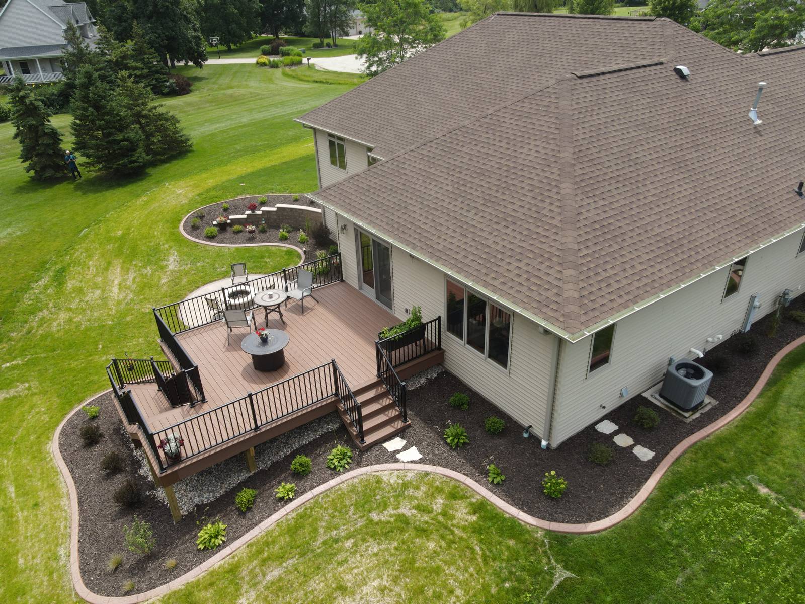 Aerial view of backyard deck and landscaped lawn