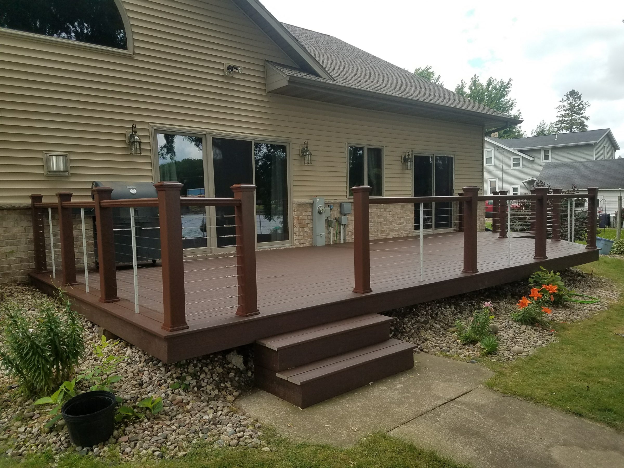 Backyard deck with railing attached to house