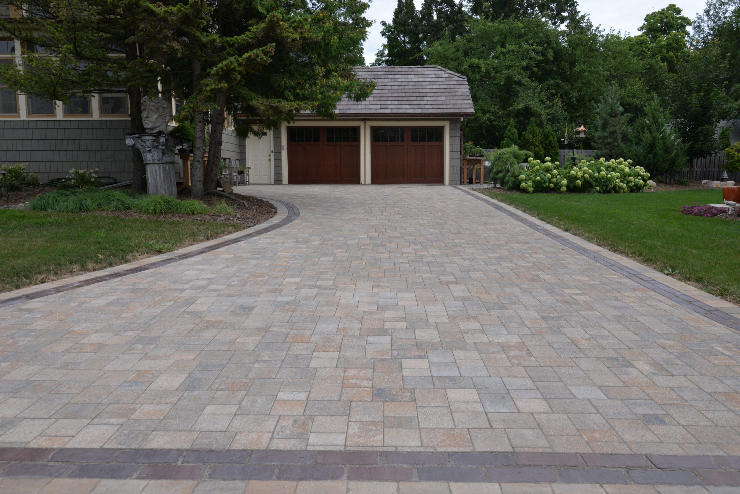 Stone driveway leading to two-car garage