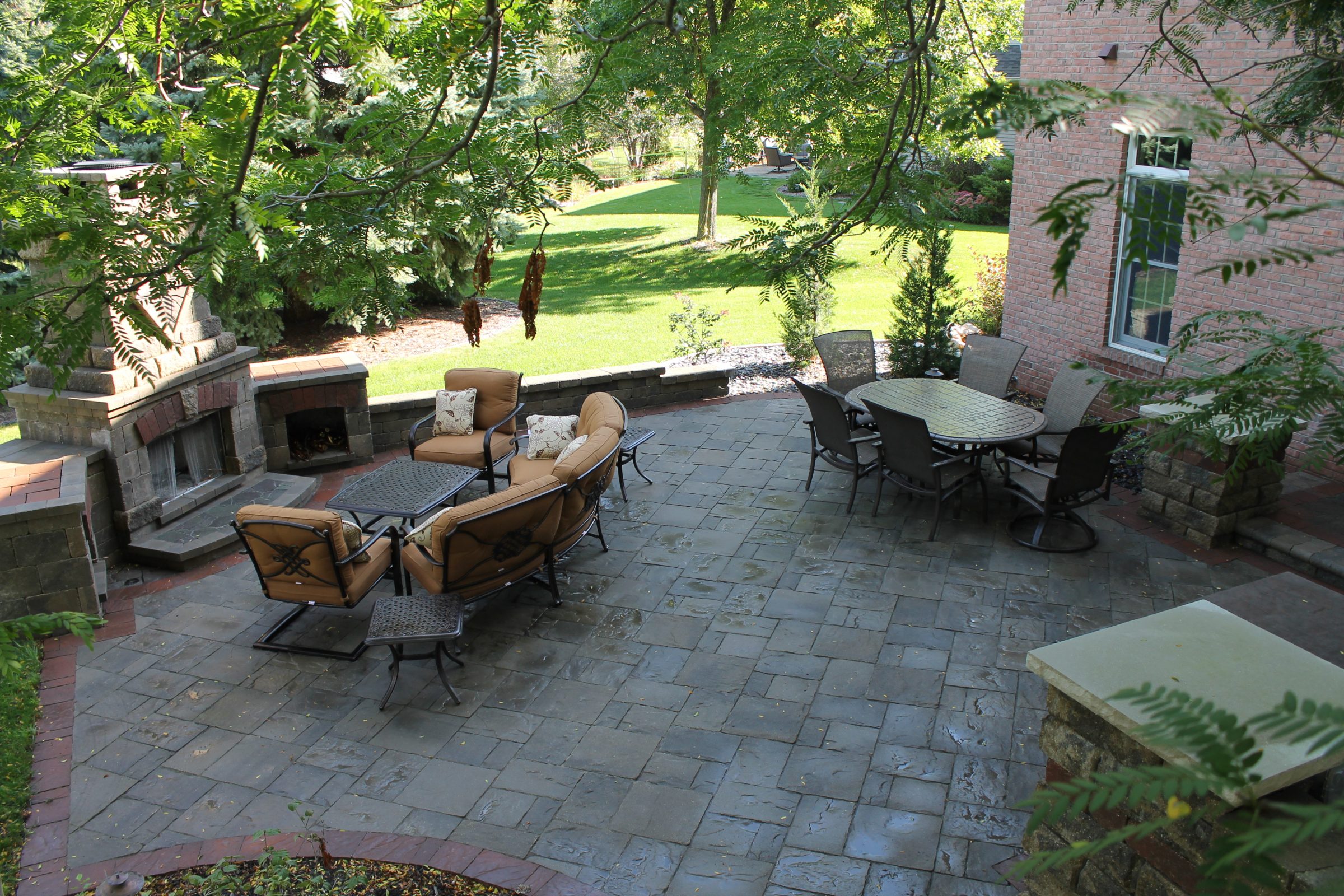 Stone patio with fireplace and outdoor seating