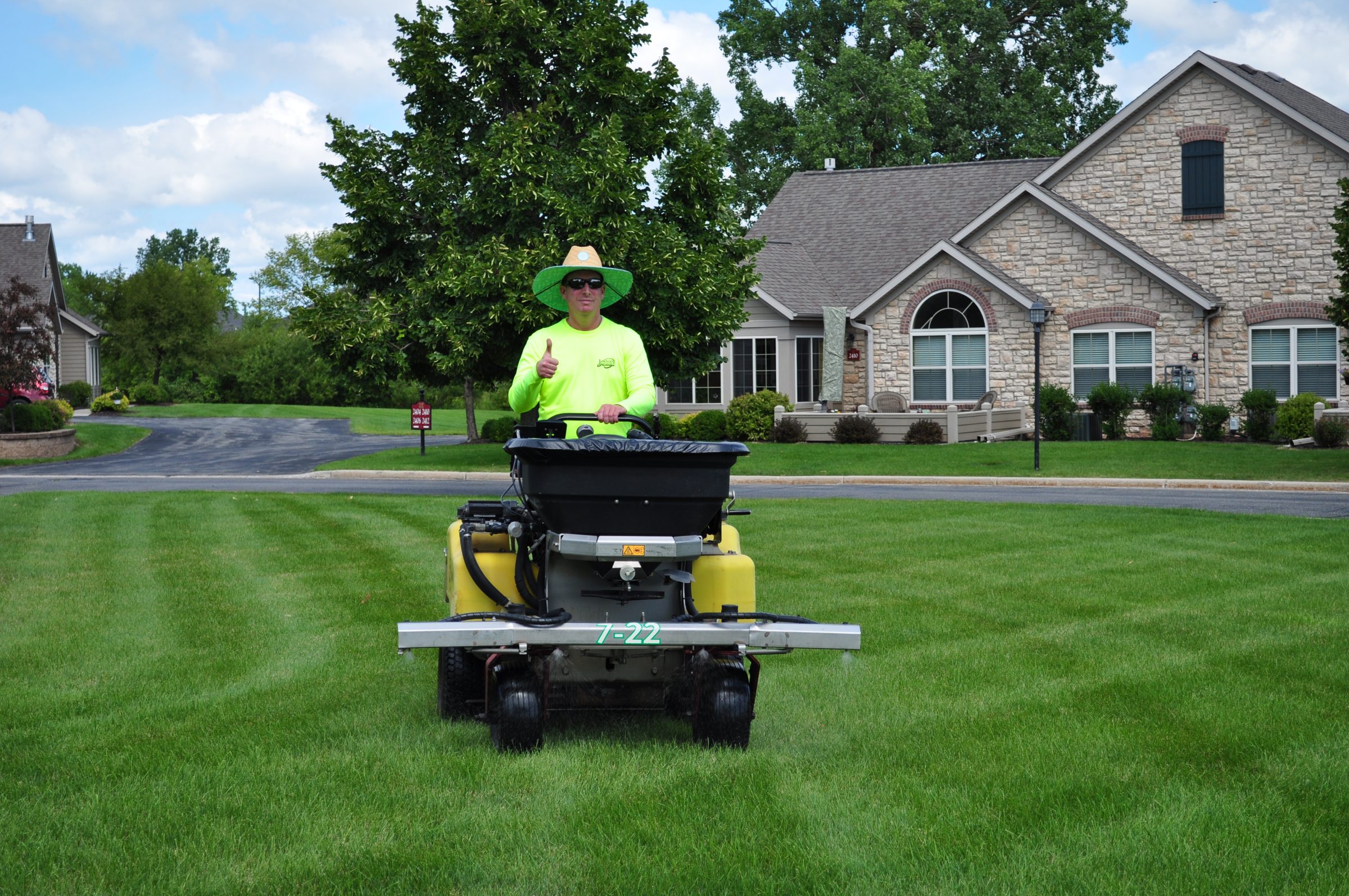 Man mowing lawn in suburban neighborhood