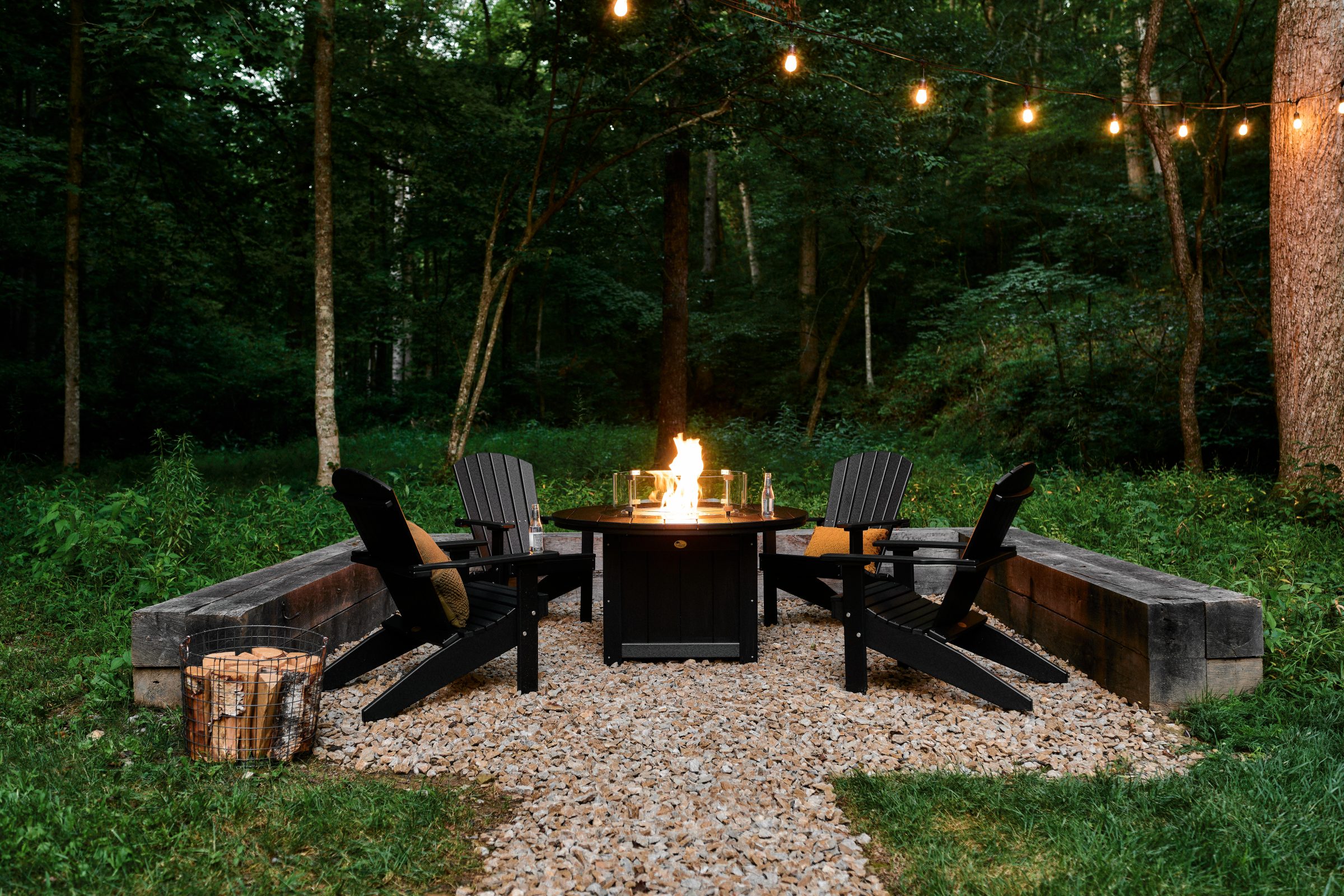 Forest patio with fire pit and Adirondack chairs