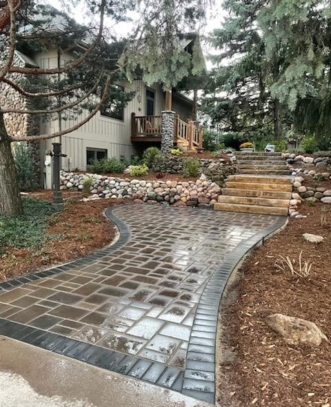 Curved paver walkway leading to house entrance
