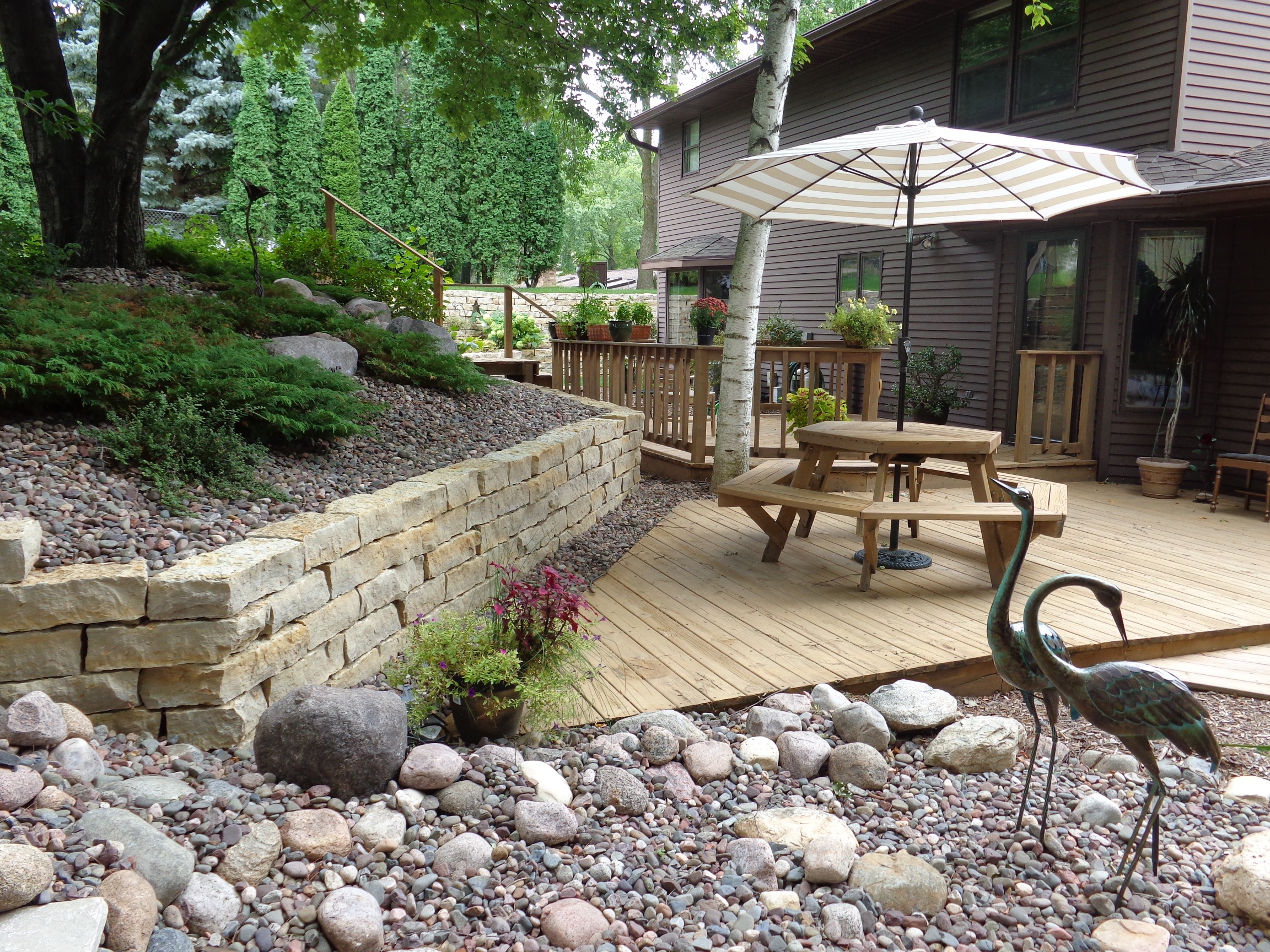 Backyard deck with picnic table and umbrella