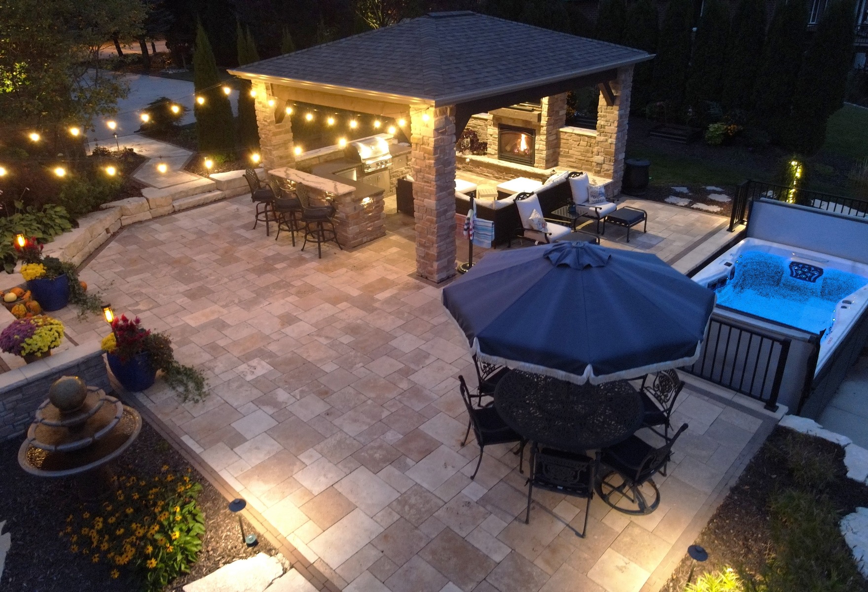 Luxury backyard patio with outdoor kitchen and hot tub