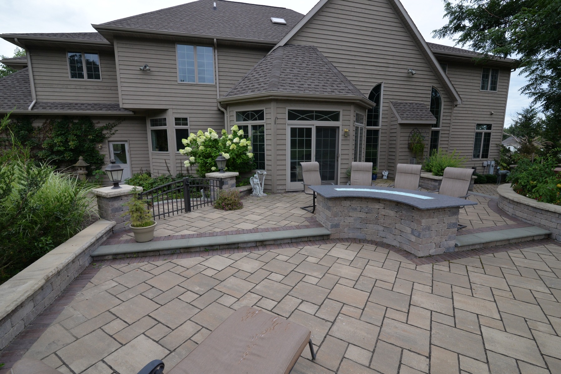 Spacious backyard patio with stone bar and seating