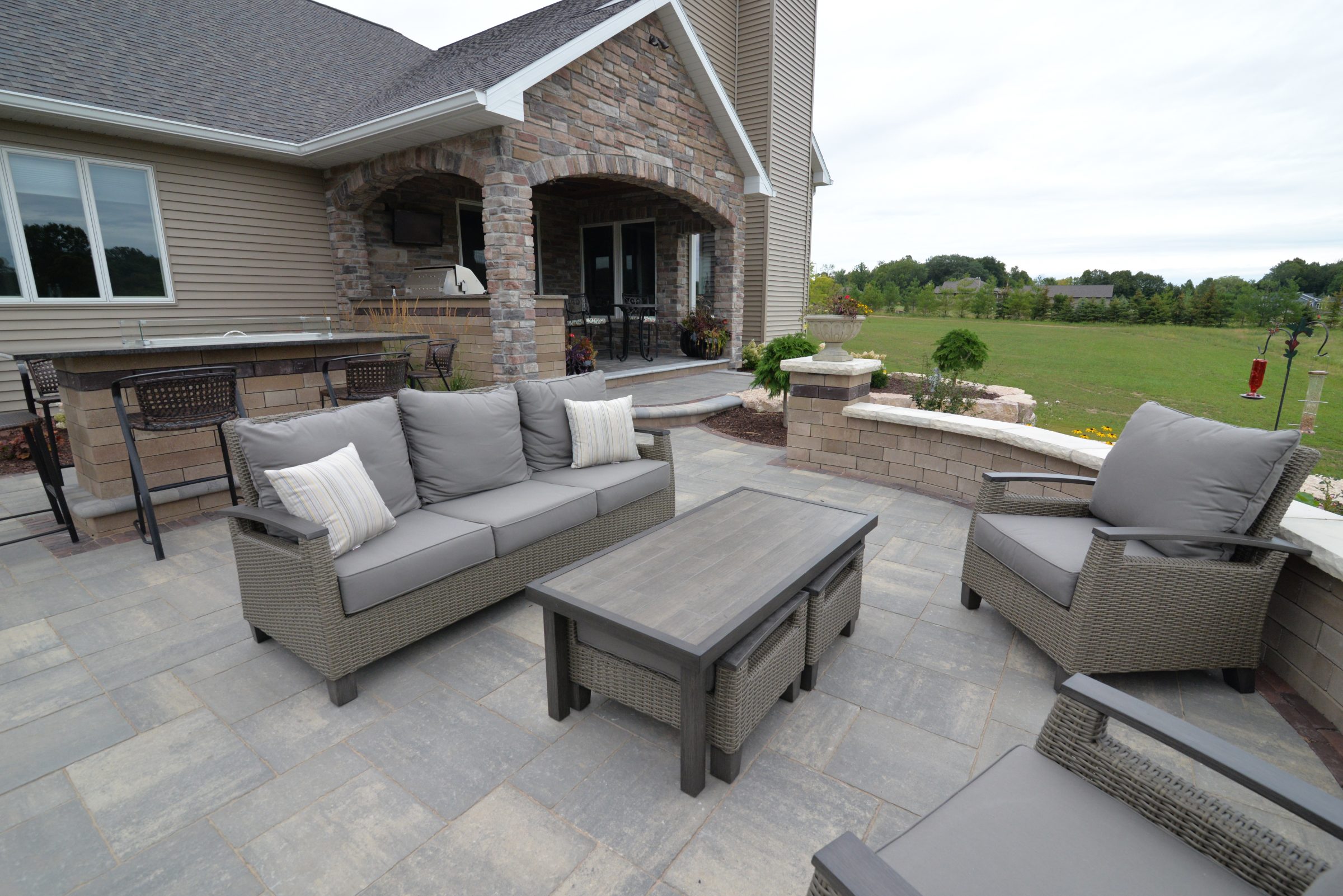 Modern backyard patio with wicker outdoor furniture