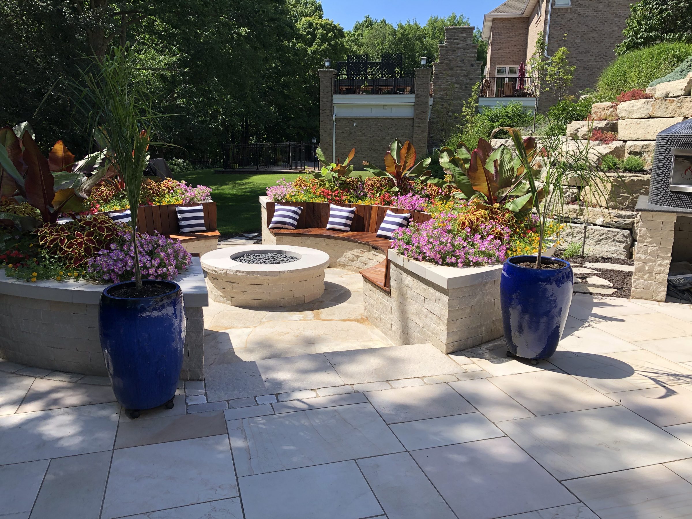 Landscaped backyard patio with fire pit and seating