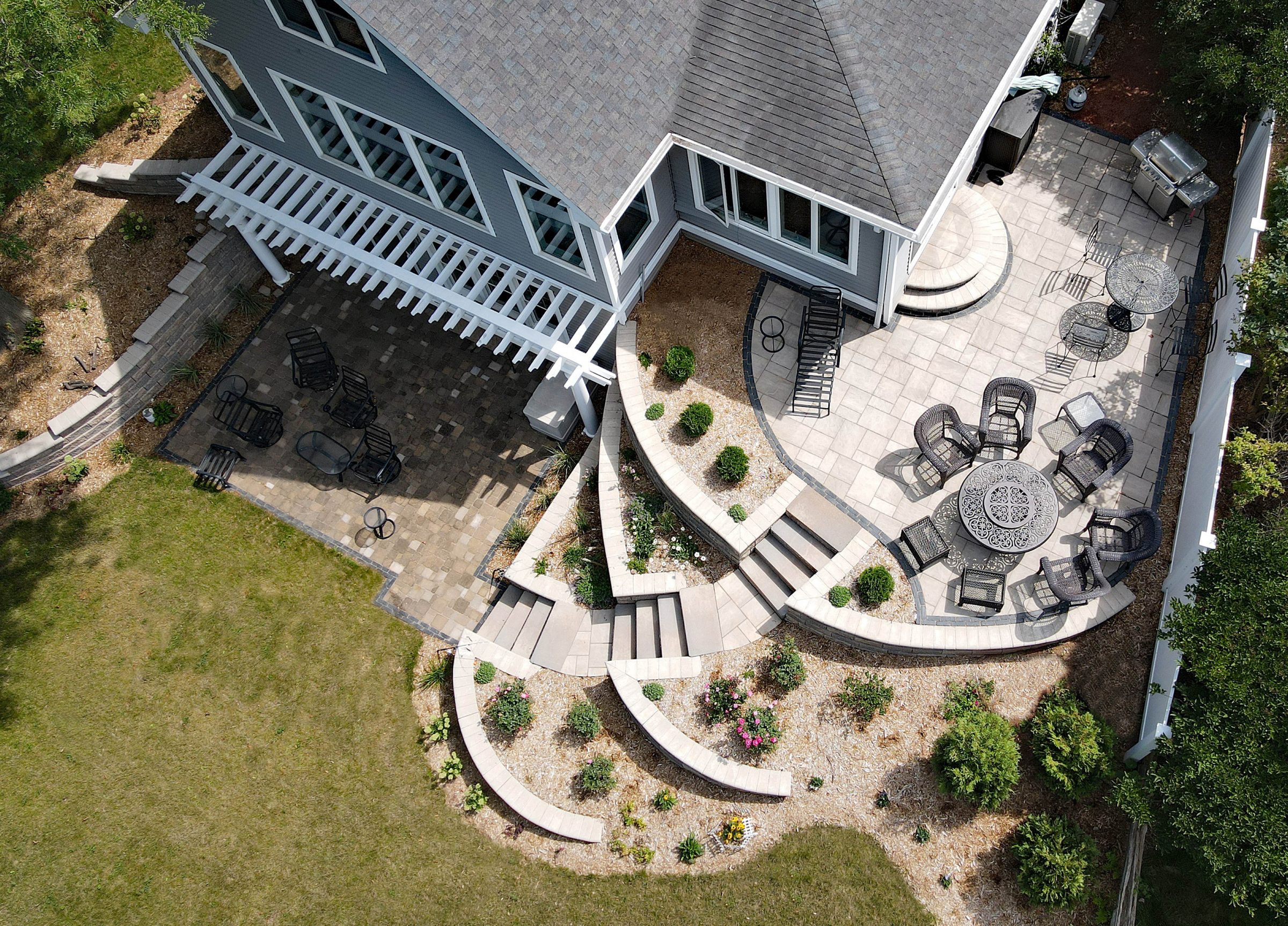 Aerial view of landscaped backyard patio with pergola