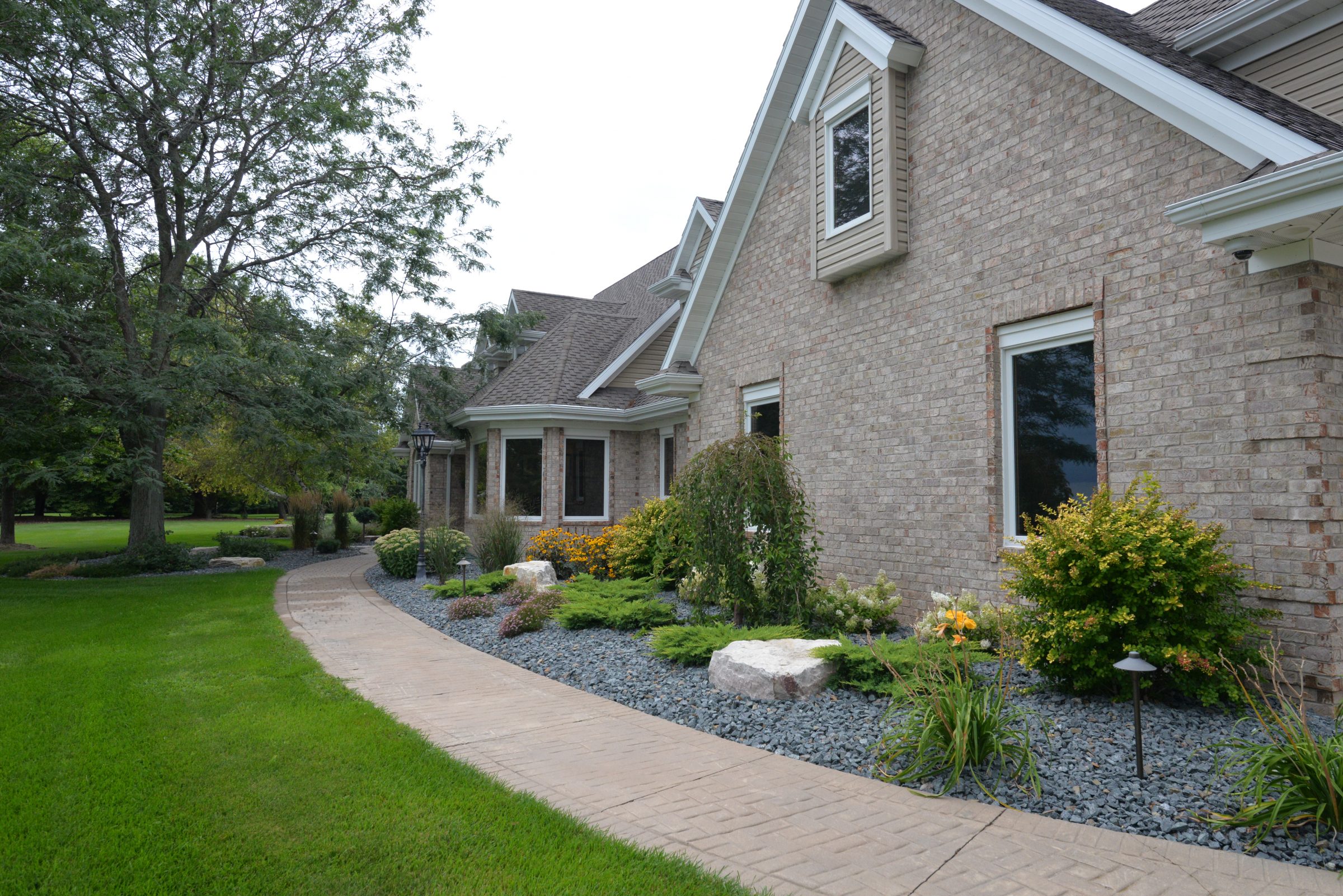 Brick suburban home with landscaped front yard