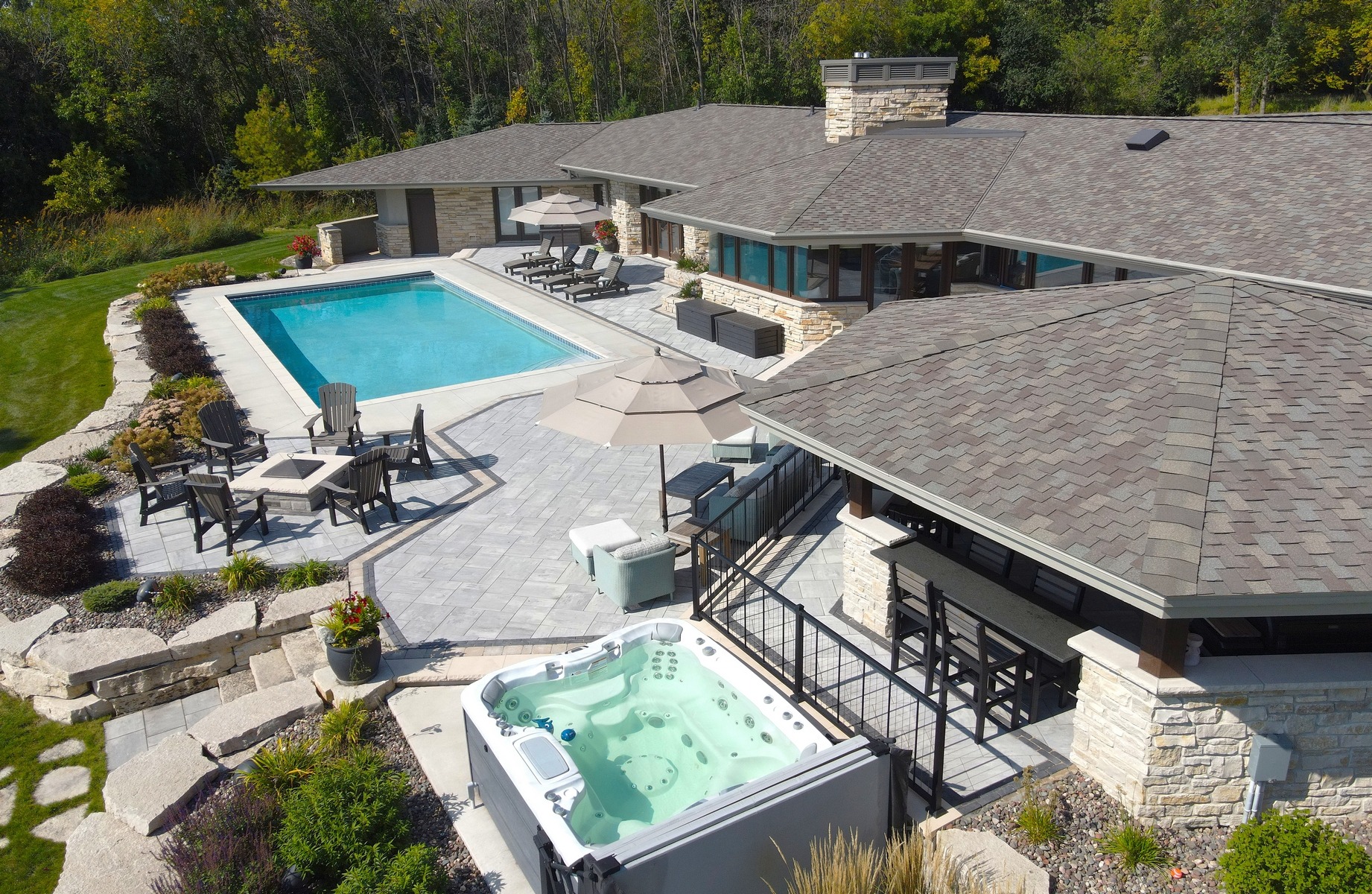 Modern home with pool, patio, and hot tub