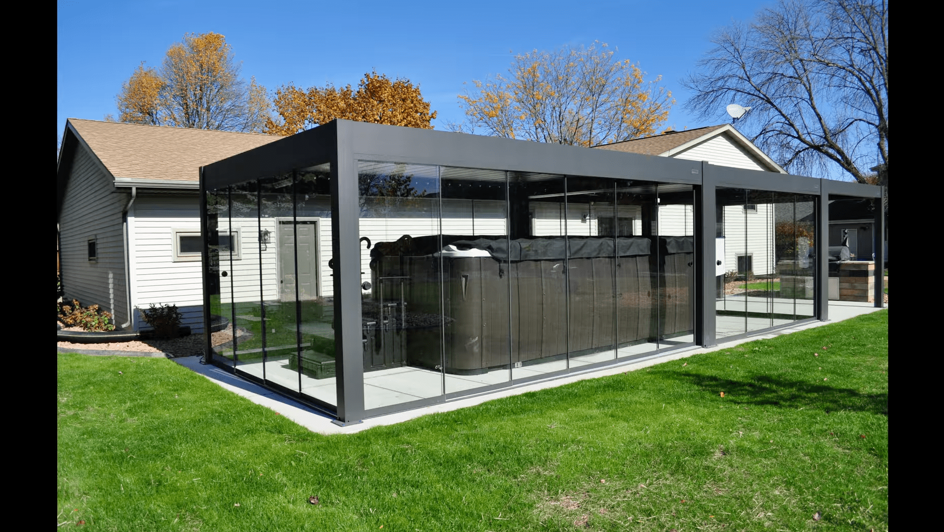 Modern glass-enclosed patio with outdoor hot tub