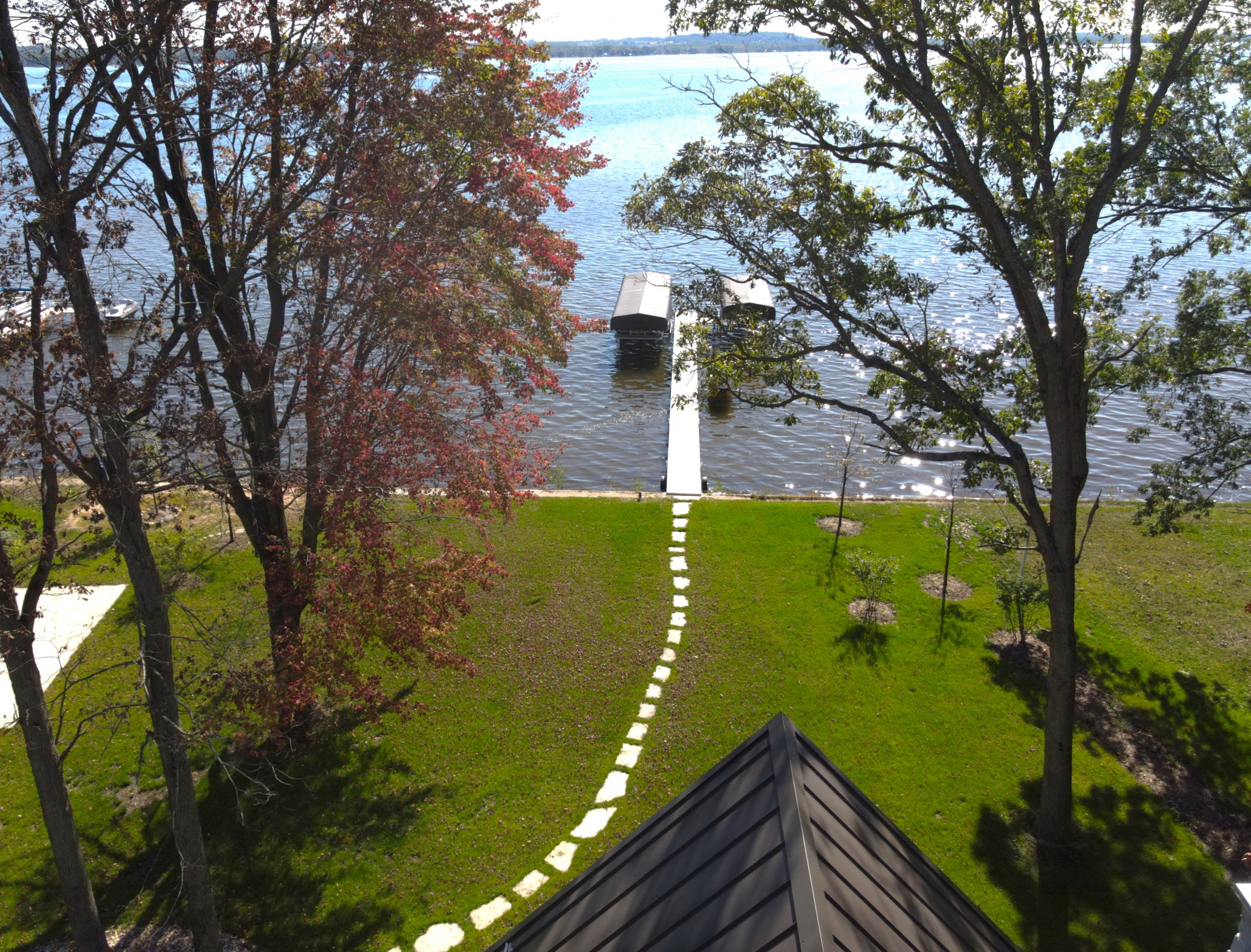Lakeside lawn with dock and boat lift