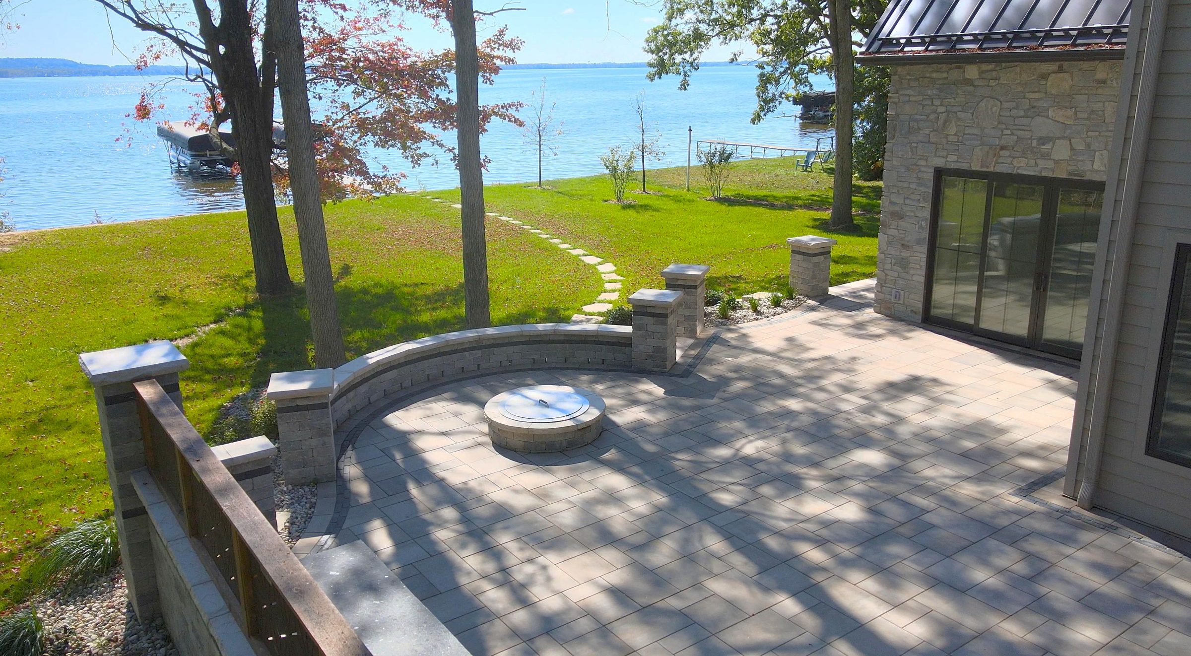 Lakeside backyard patio with fire pit and dock