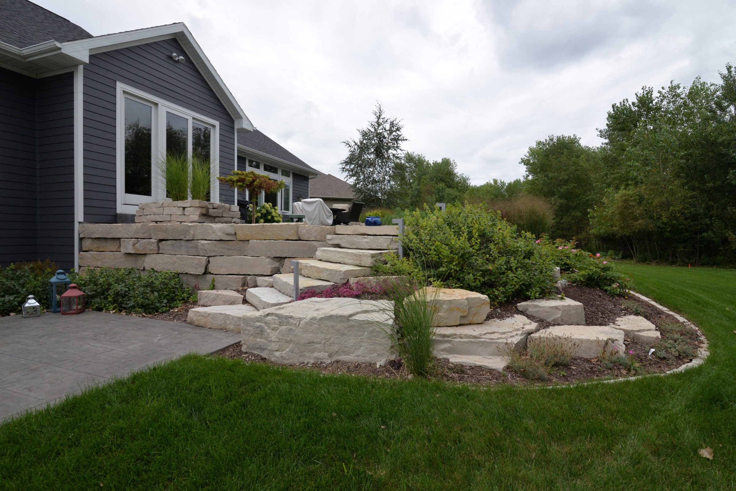 Modern home with stone retaining wall and garden