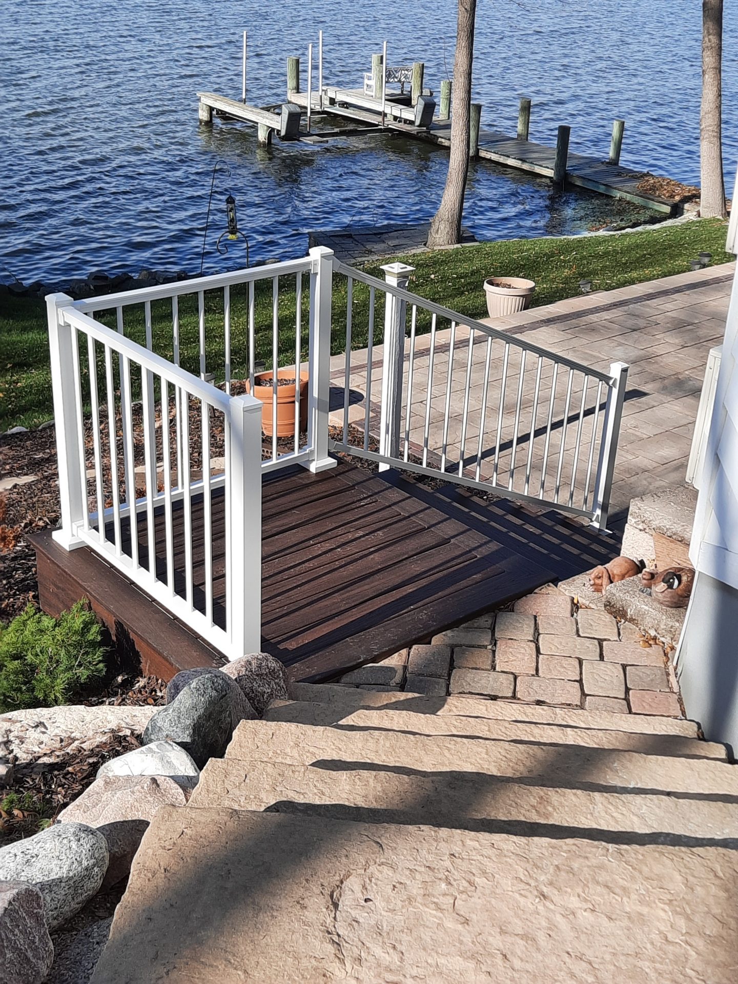 Backyard deck and dock overlooking calm lake