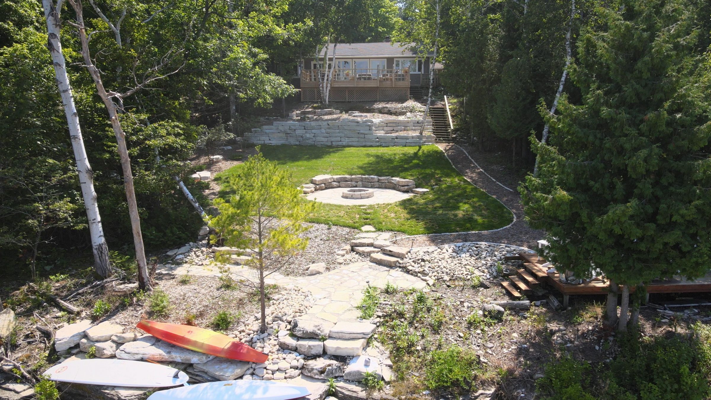 Lakeside home with terraced yard and fire pit