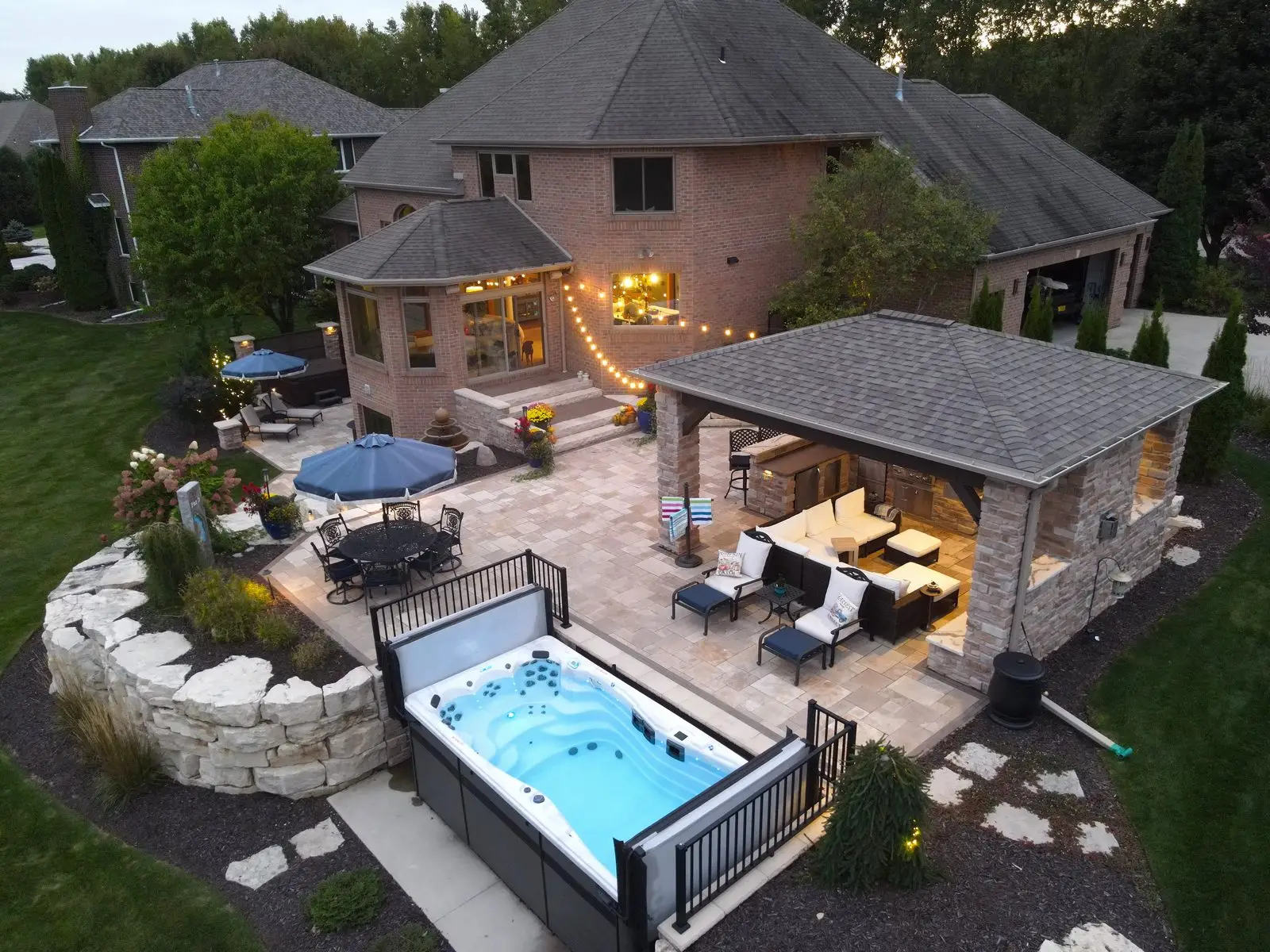 Luxury backyard patio with hot tub and pavilion