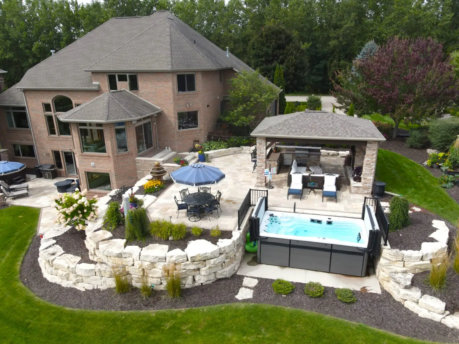 Luxury backyard patio with hot tub and pavilion