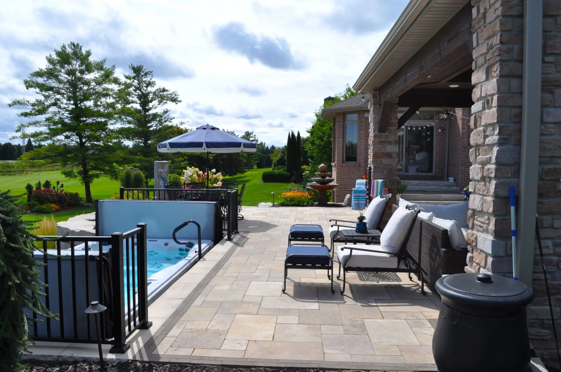 Backyard patio with hot tub and outdoor seating