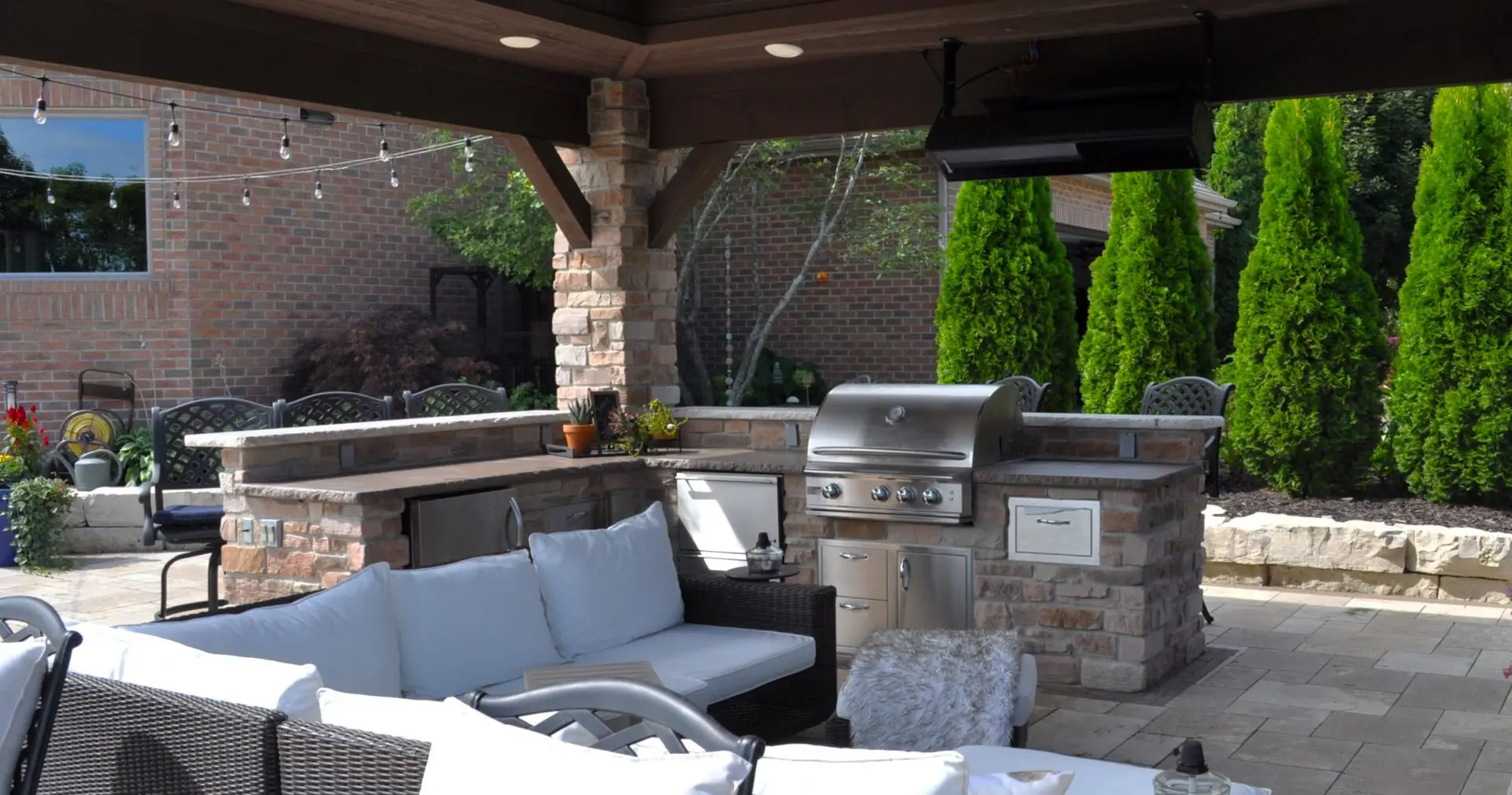 Backyard patio with outdoor kitchen and seating area