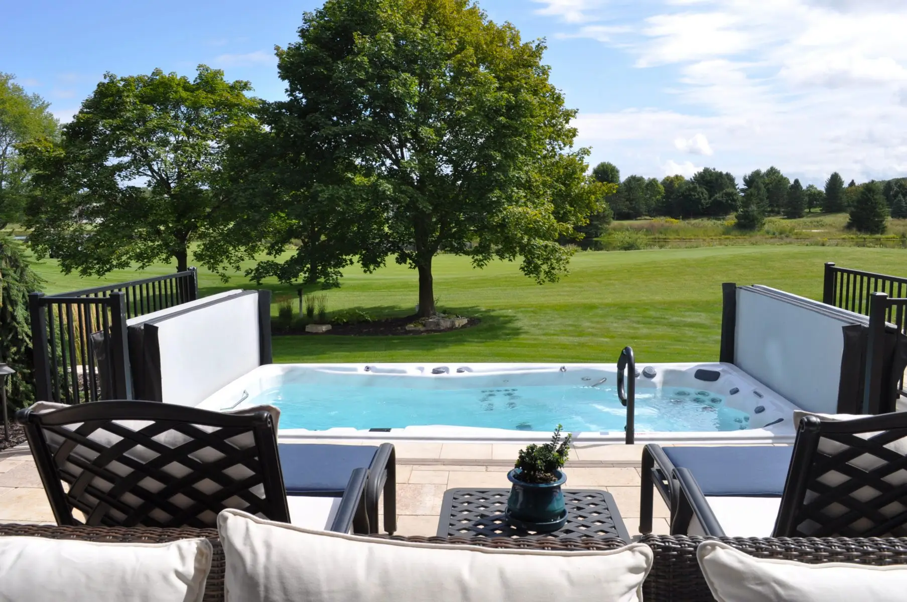 Backyard hot tub overlooking lush green lawn