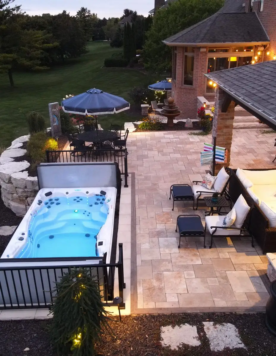 Backyard patio with hot tub and seating area