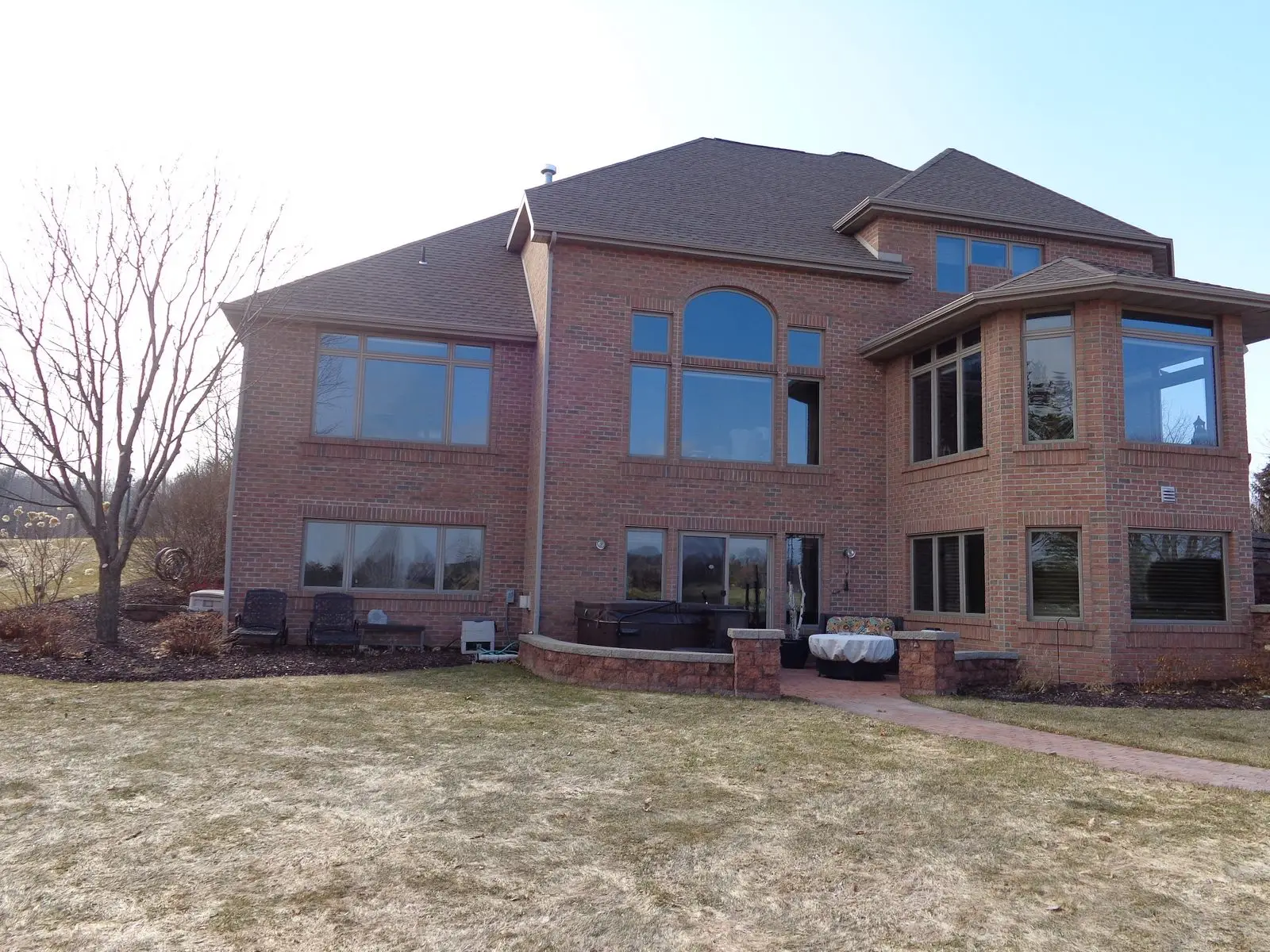 Large two-story brick house with backyard patio