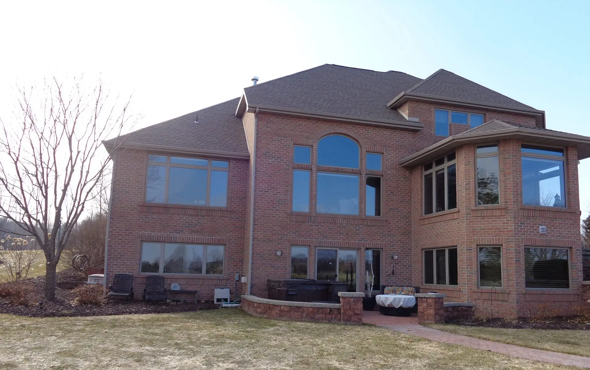 Large two-story brick house with backyard patio