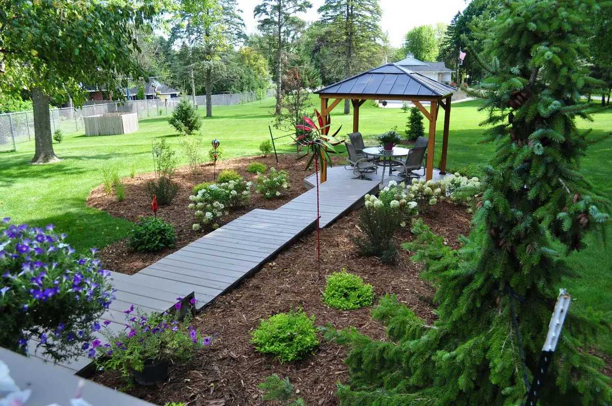 Landscaped backyard with gazebo and garden walkway